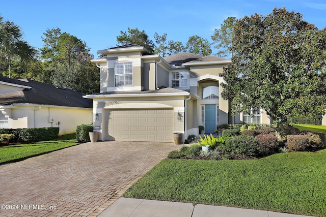 view of front of house with a garage and a front lawn