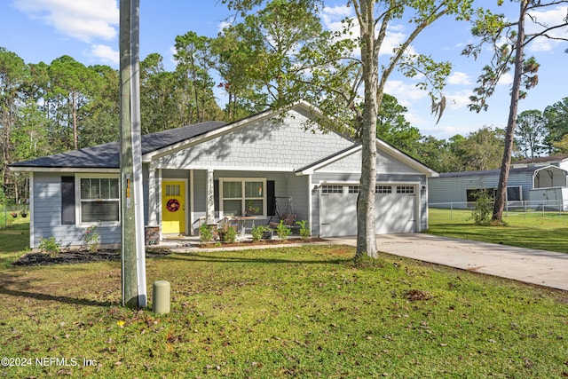 ranch-style home featuring a garage, a front lawn, and a porch