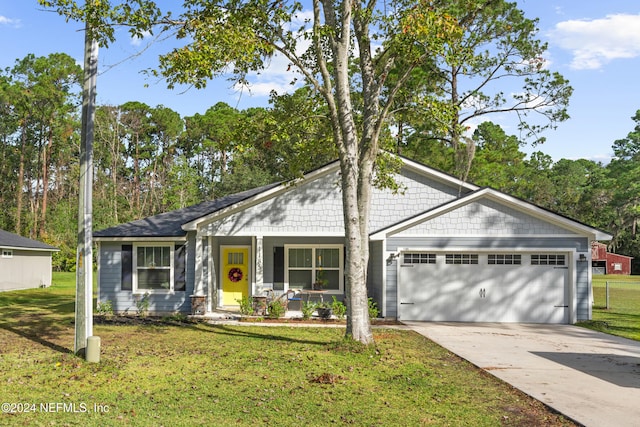 single story home featuring a porch, a front yard, and a garage