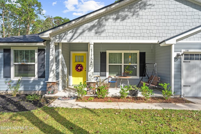 view of front facade featuring covered porch and a garage