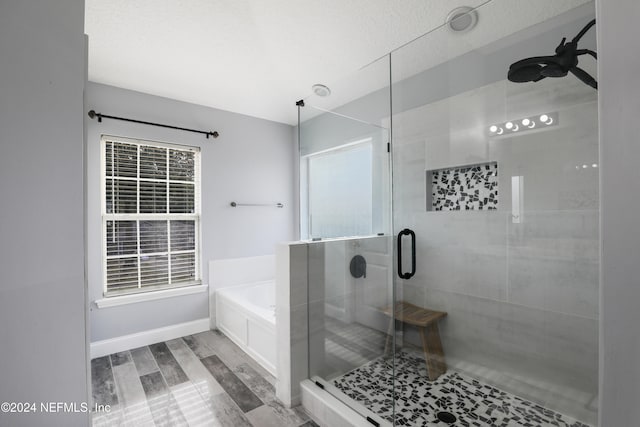 bathroom featuring independent shower and bath, wood-type flooring, and ceiling fan