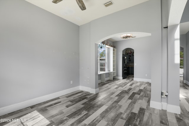 unfurnished living room with hardwood / wood-style flooring and ceiling fan