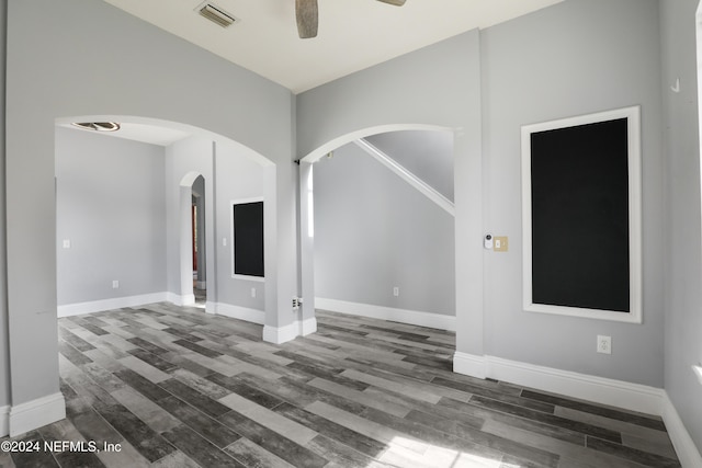 unfurnished room with ceiling fan and dark hardwood / wood-style floors