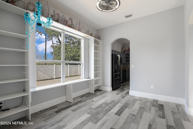 unfurnished dining area with wood-type flooring