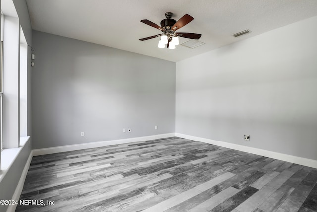 spare room with hardwood / wood-style floors, ceiling fan, and a textured ceiling