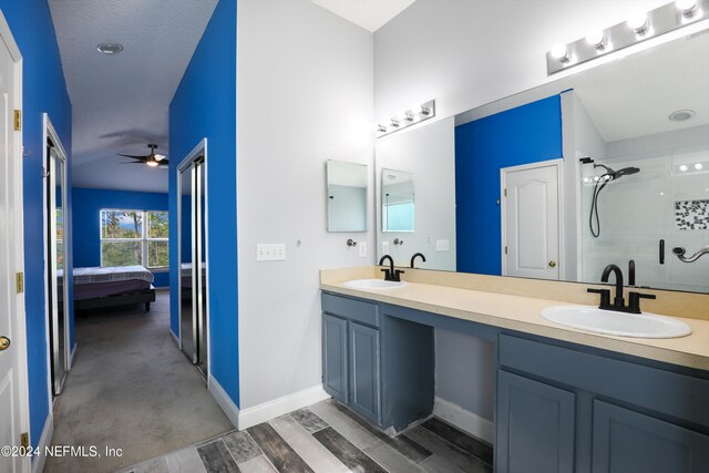 bathroom featuring wood-type flooring, ceiling fan, vanity, and a shower with door