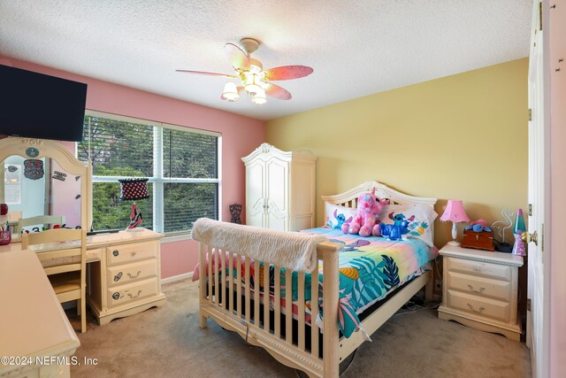 carpeted bedroom featuring ceiling fan and a textured ceiling