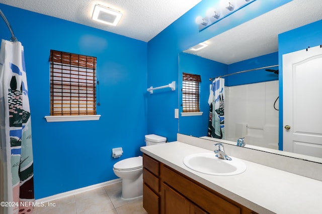 bathroom featuring walk in shower, tile patterned flooring, a textured ceiling, vanity, and toilet