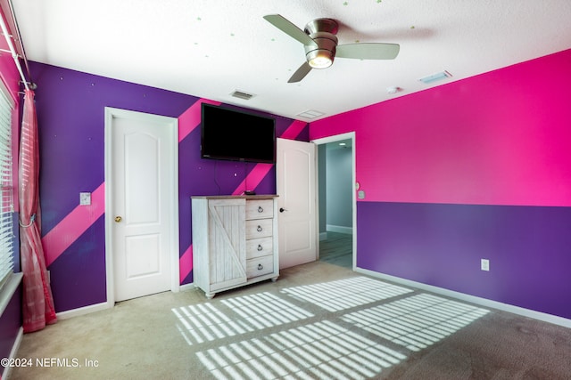 unfurnished bedroom with a textured ceiling and ceiling fan