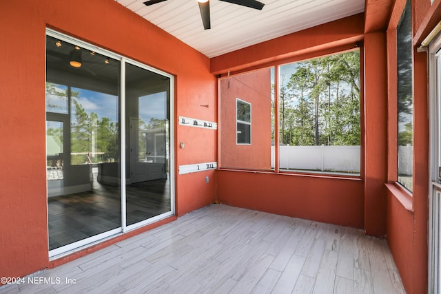 unfurnished sunroom featuring ceiling fan