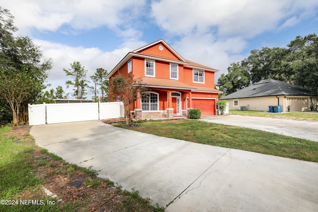 view of front of home with a front lawn and a garage