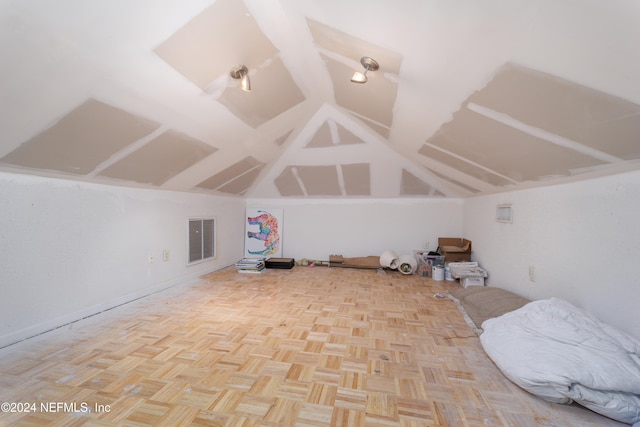 additional living space with light parquet floors and lofted ceiling