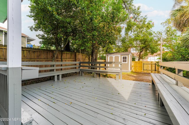 wooden deck featuring a storage unit