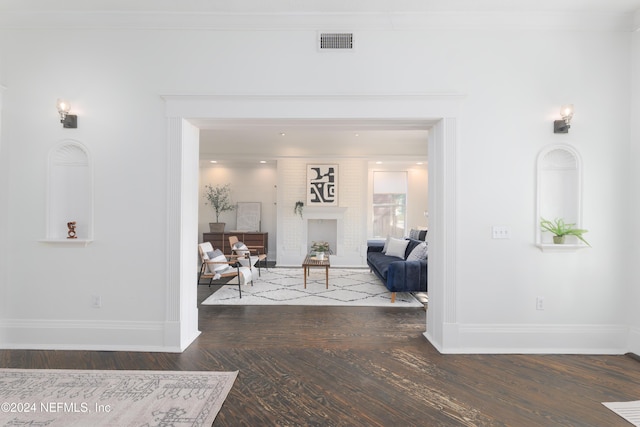 interior space featuring crown molding and dark wood-type flooring