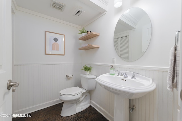 bathroom featuring sink, toilet, wood-type flooring, and crown molding