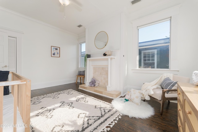 living room with dark hardwood / wood-style floors, a wealth of natural light, and crown molding