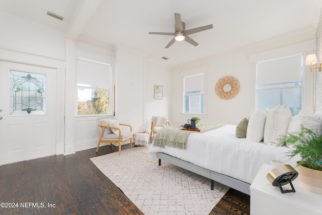 bedroom featuring dark hardwood / wood-style floors, ceiling fan, and crown molding