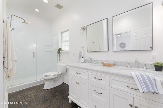 bathroom with walk in shower, vanity, crown molding, wood-type flooring, and toilet