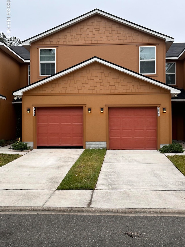 doorway to property with a garage