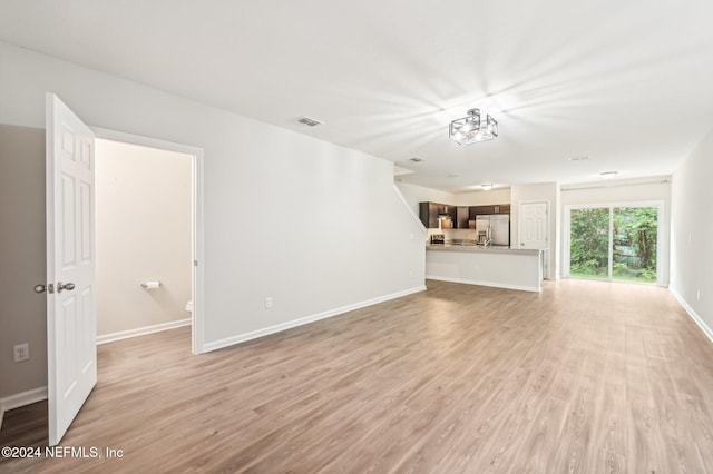 unfurnished living room featuring light wood-type flooring