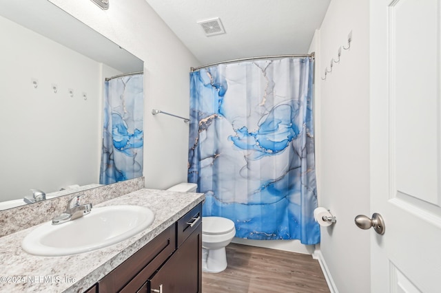 bathroom featuring vanity, toilet, hardwood / wood-style flooring, and a shower with curtain