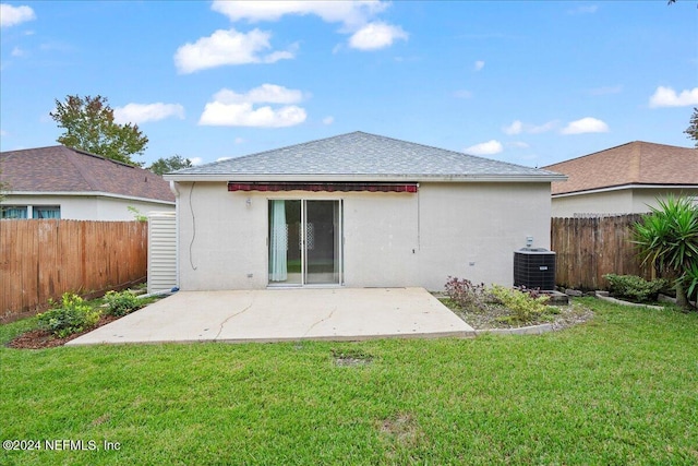 back of property with a patio, stucco siding, central AC, and roof with shingles