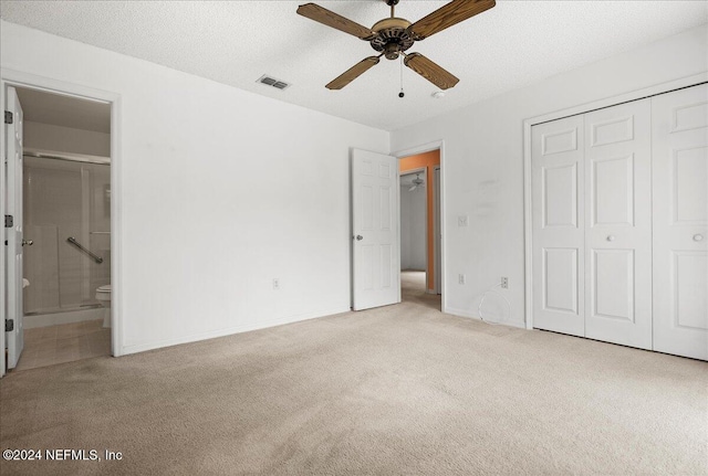 unfurnished bedroom featuring carpet flooring, a closet, ensuite bathroom, and baseboards