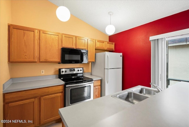 kitchen featuring black microwave, stainless steel electric range, freestanding refrigerator, vaulted ceiling, and a sink