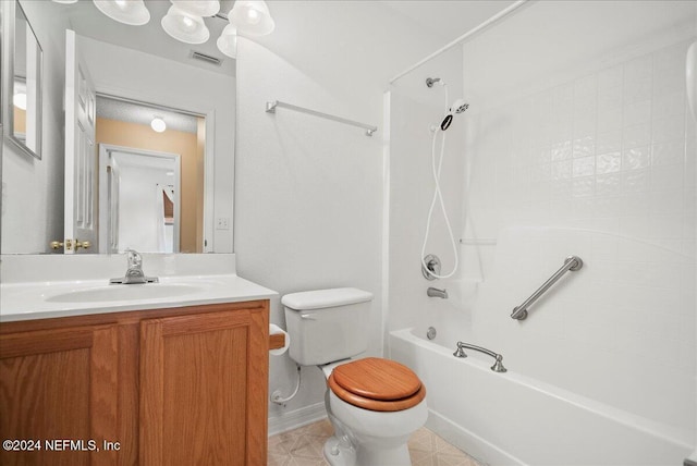 bathroom with vanity, washtub / shower combination, toilet, and baseboards