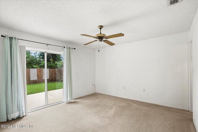 unfurnished room with light carpet, a ceiling fan, a textured ceiling, and baseboards