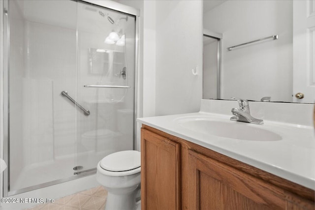 full bathroom with toilet, a stall shower, and vanity