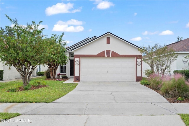 ranch-style house with driveway, stucco siding, a garage, and a front yard