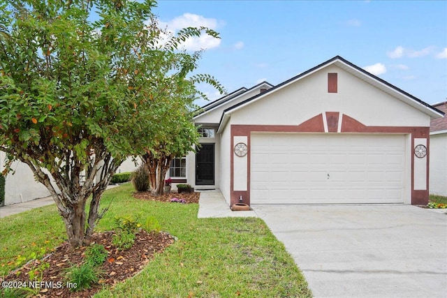 view of front of property featuring a front yard and a garage