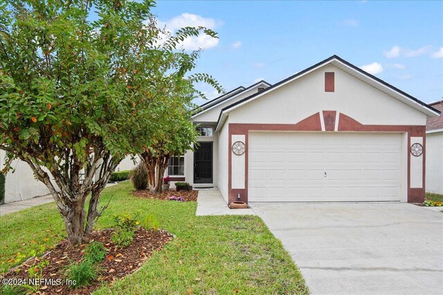 single story home with stucco siding, an attached garage, driveway, and a front yard