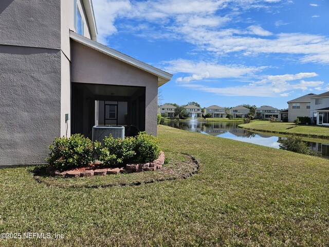 view of yard featuring a water view and a residential view