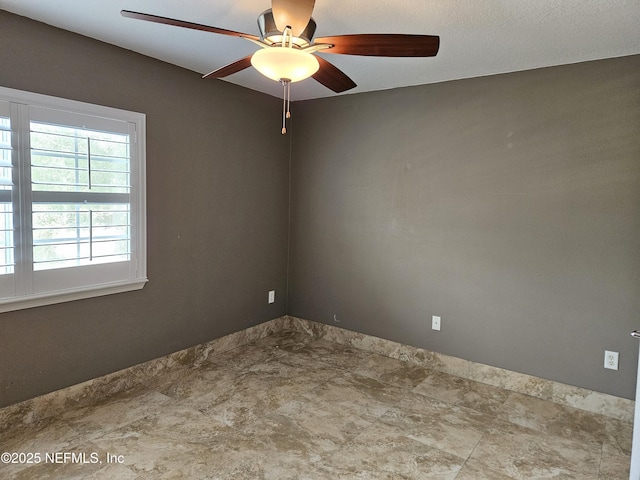 unfurnished room with ceiling fan