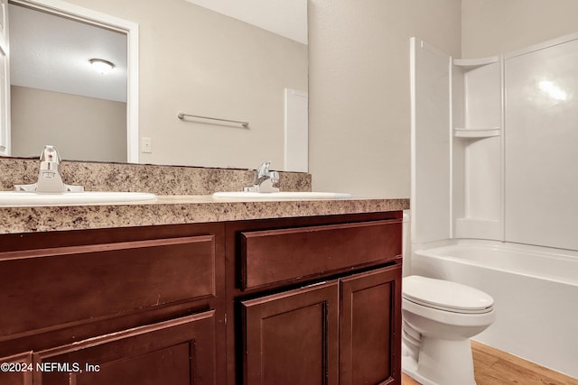 full bathroom featuring vanity, toilet, wood-type flooring, and bathing tub / shower combination