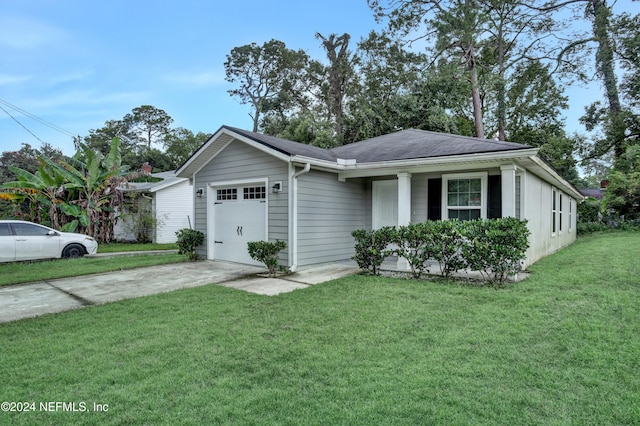 ranch-style house featuring a front lawn and a garage