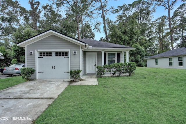 8956 3rd Ave, Jacksonville, FL 32208 - view of front of home with a front yard, a garage, and driveway
