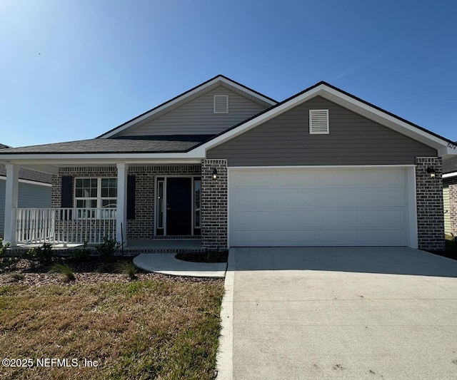 ranch-style house with a porch, concrete driveway, brick siding, and an attached garage