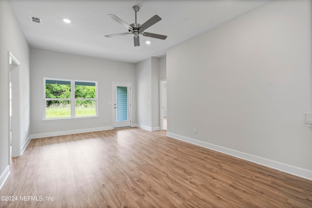 empty room with light wood finished floors, recessed lighting, visible vents, and baseboards