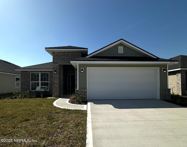 view of front facade with driveway, an attached garage, a front lawn, and brick siding