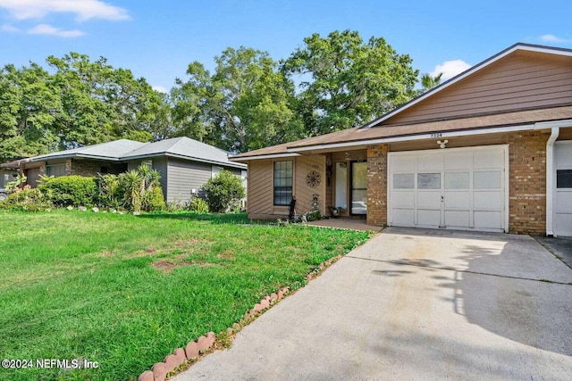 single story home featuring a front yard and a garage