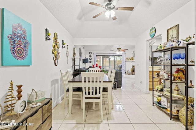 dining room featuring ceiling fan, a textured ceiling, and light tile patterned flooring