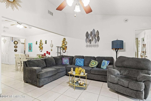 living room with vaulted ceiling, ceiling fan, and light tile patterned floors