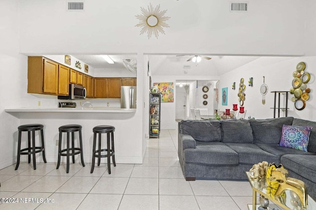 living room with ceiling fan and light tile patterned floors