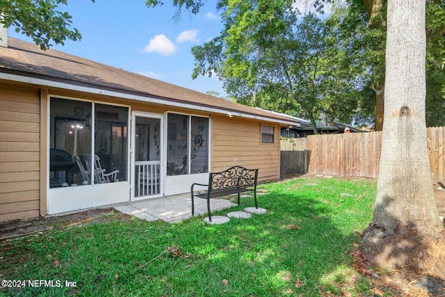 back of property featuring a lawn