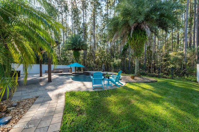 view of yard featuring a fenced in pool and a patio area