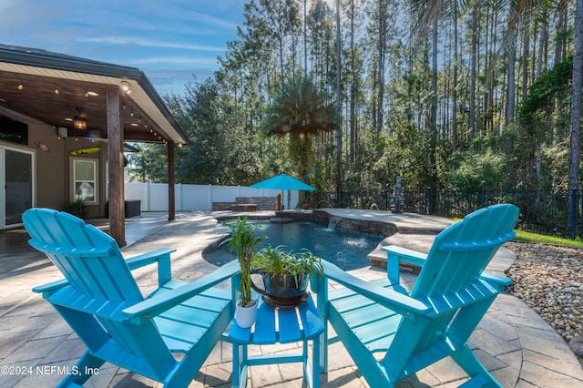 view of swimming pool featuring ceiling fan and a patio area