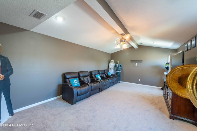 cinema room with lofted ceiling with beams, ceiling fan, and light colored carpet